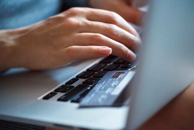 hands-using-laptop-and-credit-card-on-it.jpg